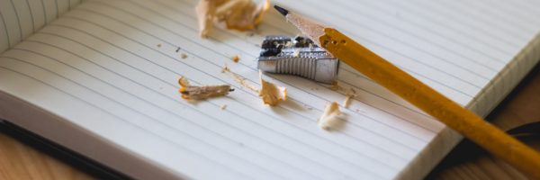 pencil with sharpener and exercise book