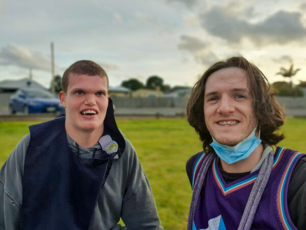 Two friends smiling standing next to each other